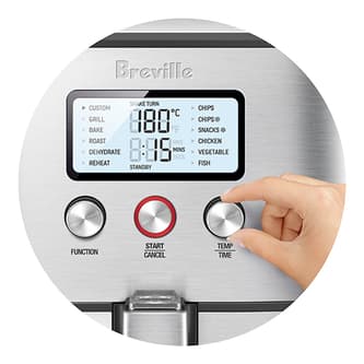 A person adjusting the temp and time dial