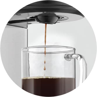 Coffee flowing from the product into a jug.