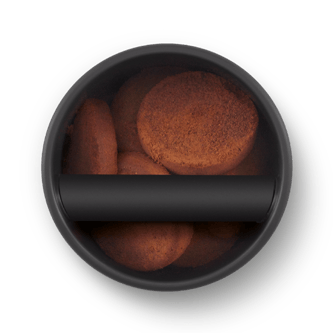 Ariel view of espresso ground pucks in the knock box 10