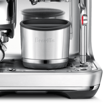 close up of the knock box 10 placed in an espresso machine