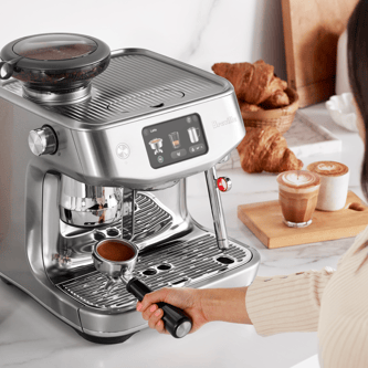 Woman holding portafilter with tamped ground beans