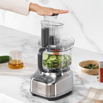 Sliced cucumbers in the food processor bowl