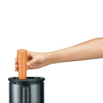A carrot being fed down the chute.