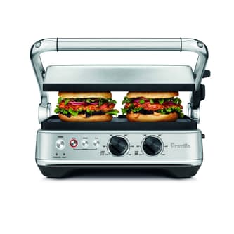 Two sandwiches being pressed in the grill.
