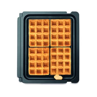 Four cooked waffles in sitting in compatible waffle grill plates.