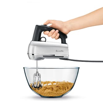 Someone mixing a batter in a bowl.