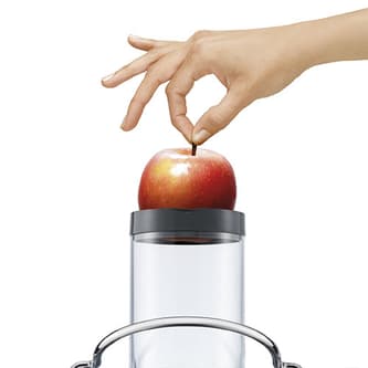 User dropping a whole red apple down the feed chute.