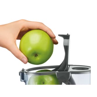 Whole green apples put through chute to juice.
