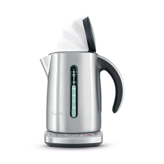 Side view of kettle showing the lid opening slowly.