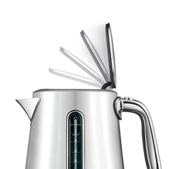 Side view of kettle with lid opening slowly.
