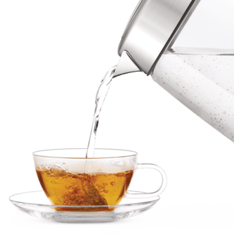 The smart crystal luxe kettle being poured into cup with tea