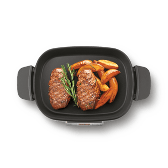 Overhead view of cooker with beef and potato wedges