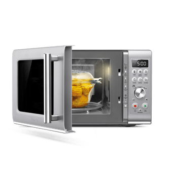 Microwave door open showing bowl of cooked sweetcorn.