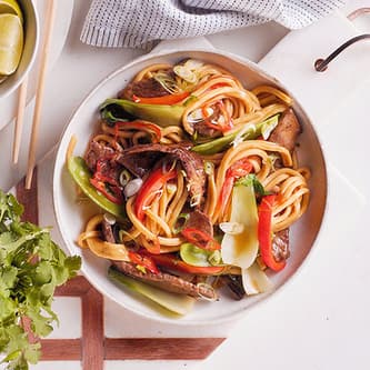 Bowl of pasta and vegetables that was defrosted or reheated in the microwave.