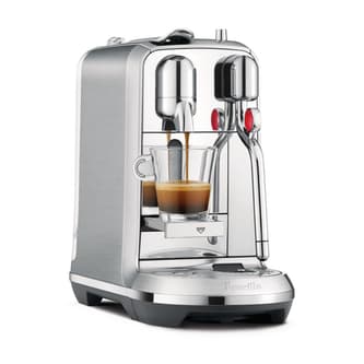 Side view of machine with espresso with latte on top.