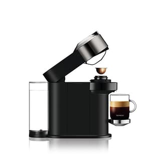 Side view of the machine with black coffee and capsule