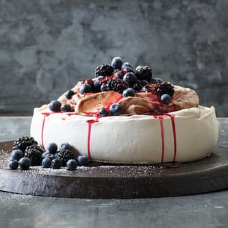 Cake on the wooden top with blueberries on the side