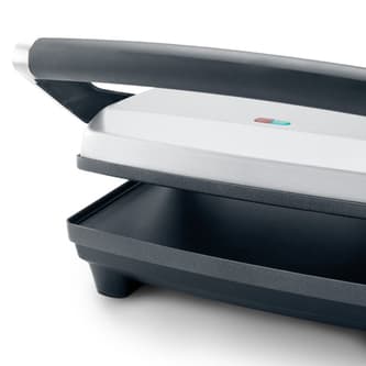 Press with top grill raised.