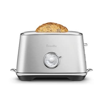View of thickly sliced bread fitting in toaster with wider slots.