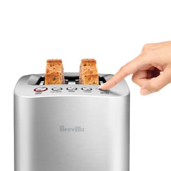 Side view of toaster with toast lowered by pressing a button.