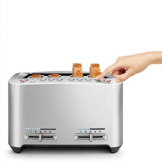 View of thickly sliced bread fitting in toaster with 4 wide slots.