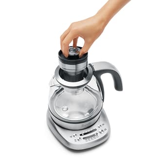 Top view of kettle with person removing basket.