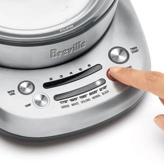 View of kettle with person selecting steep button.