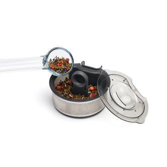 Loose leaf tea being added to basket.