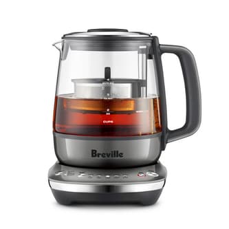 Side view of kettle with tea basket descending.