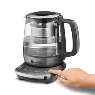 View of kettle with person selecting strength button.