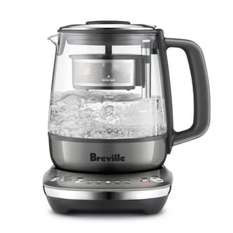 Side view of kettle with infuser boiling water.