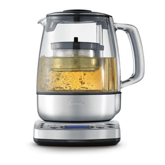 Side view of kettle with tea basket descending.