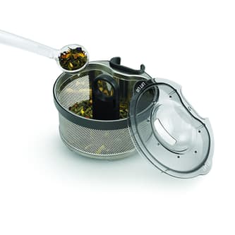 Loose leaf tea being added to basket.