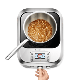 Person adjusting temperature dial of the precision cooker.