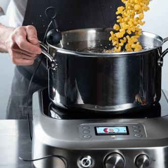Person adjusting temperature dial of the precision cooker.