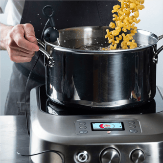 Person adjusting temperature dial of the precision cooker.