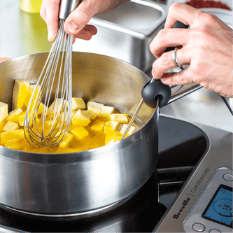 Person adjusting temperature dial of the precision cooker.