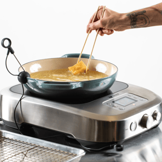 Person adjusting temperature dial of the precision cooker.