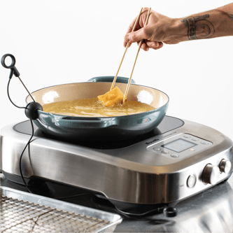 Person adjusting temperature dial of the precision cooker.