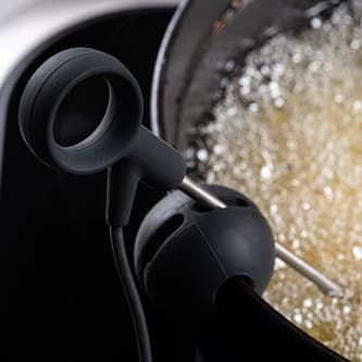 A probe is dipped in a bubbling pot of oil.