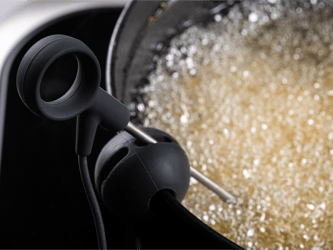 A probe is dipped in a bubbling pot of oil.