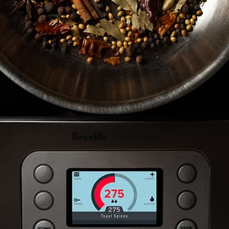 The LED screen on the precision cooker shows the temperature of the spices being toasted in the pot.
