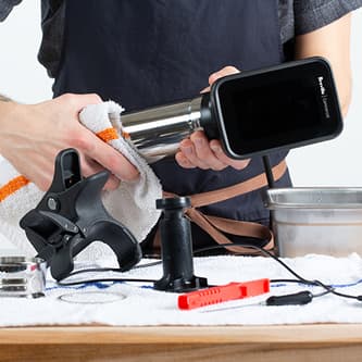 A person cleans the cylindrical component of the HydroPro™ with a cloth.