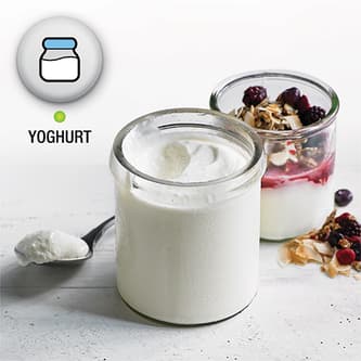 Jar of freshly made yoghurt with rasberries and muesli.