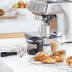 Portafilter, puck sucker, milk jug, latte, croissants.