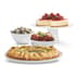 Cheesecake on a cake stand, a green salad in a bowl, meatballs in a bowl, and a savoury tarte tatin