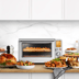 The Smart Oven Air Fryer XL with hot chips, a roast chicken and completed meals