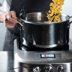 Person adjusting temperature dial of the precision cooker.