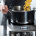 Person adjusting temperature dial of the precision cooker.