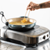 Person adjusting temperature dial of the precision cooker.
